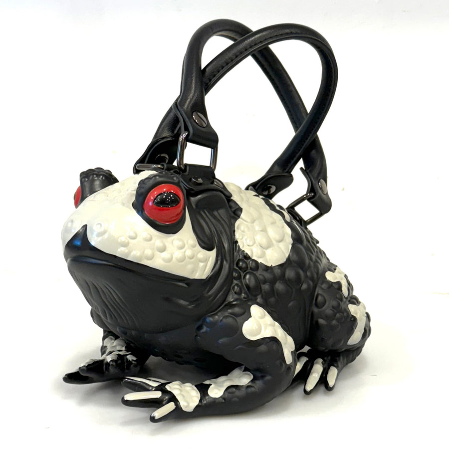 Black skeleton frog handbag with red eyes on a white background